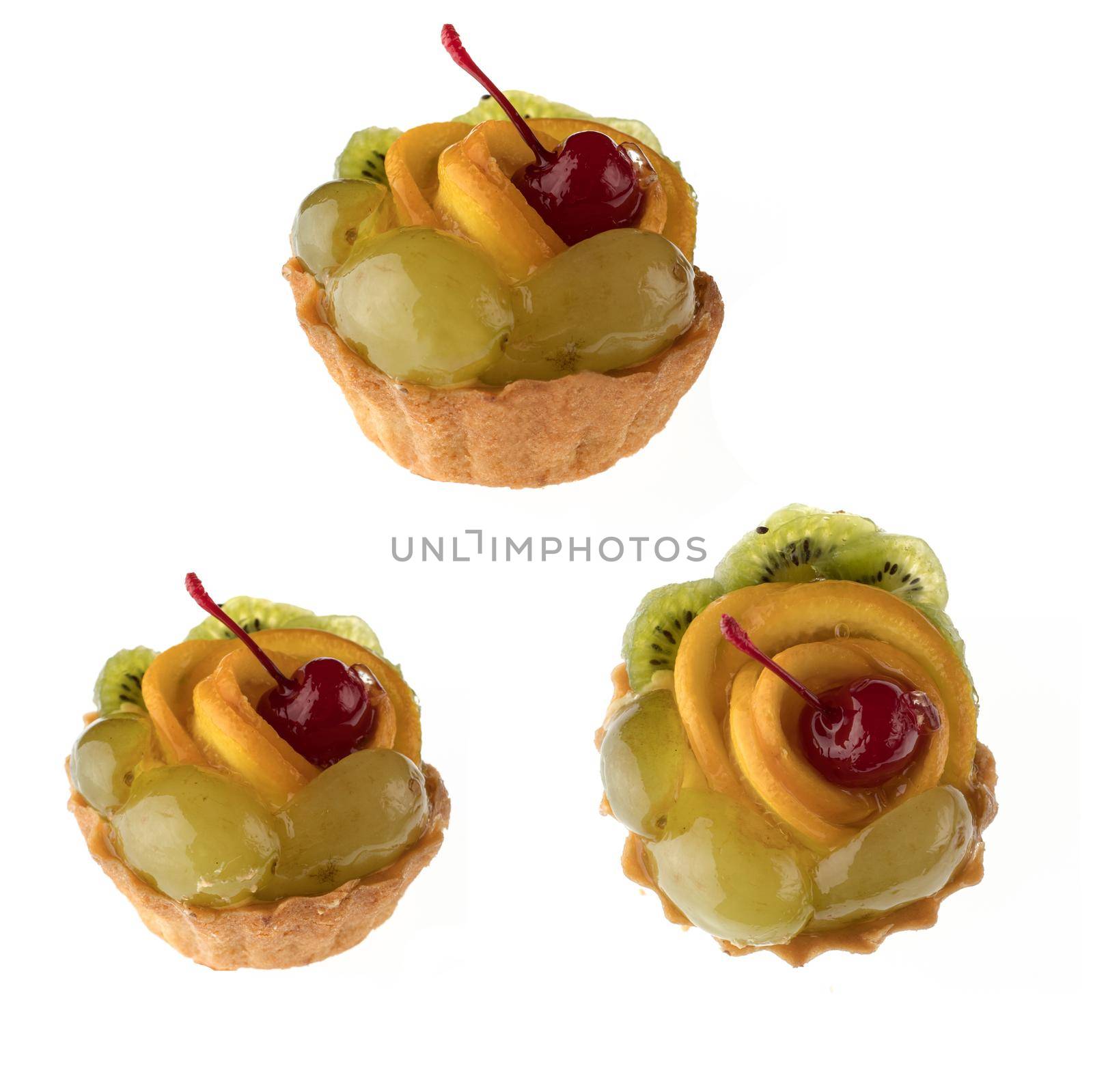 Dessert, fruit cake, with cherry grapes and orange slices, on a white background in isolation, collage