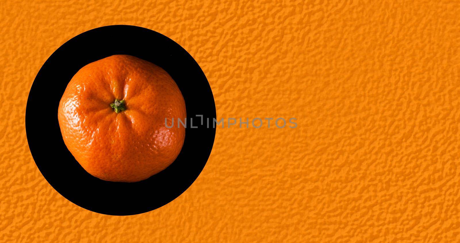 Ripe whole tangerine, on a black background in isolation, place under the text on the background of the texture of the peel of a tangerine by A_A