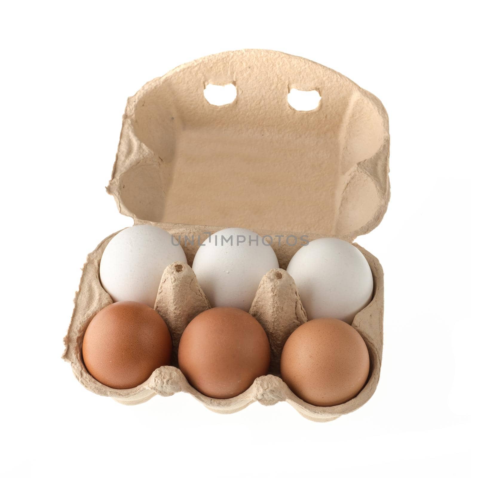 Chicken eggs in a paper disposable tray, in the amount of six pieces, on a white background in isolation