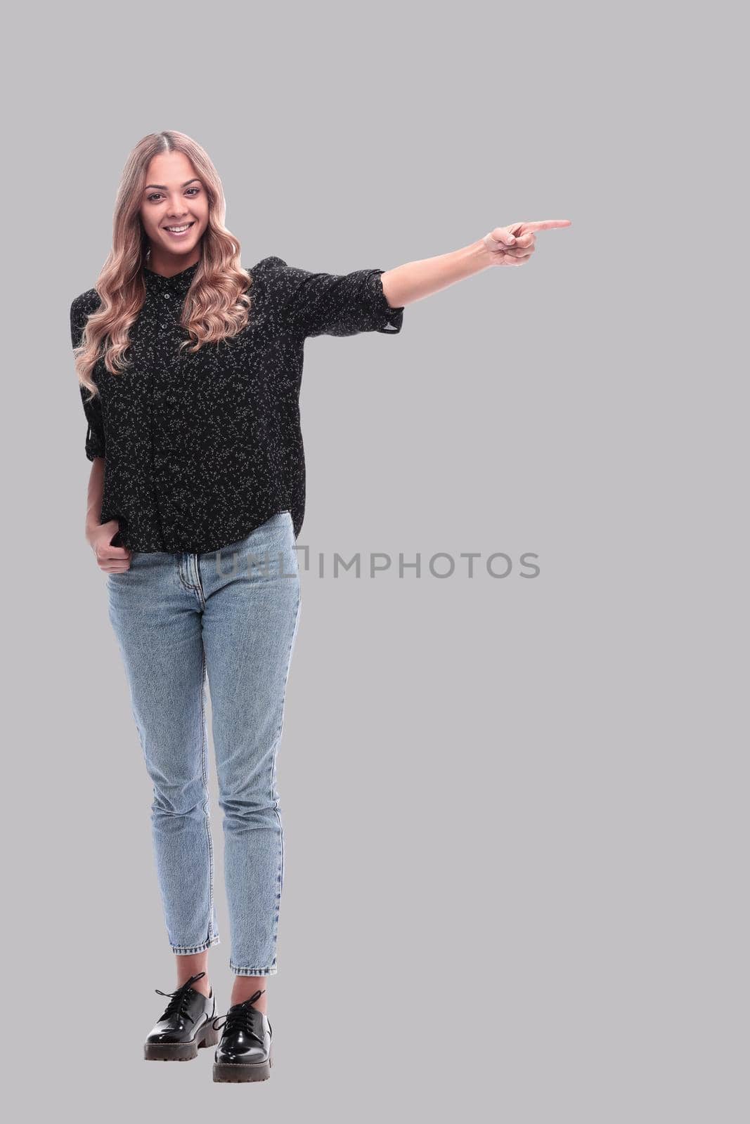 in full growth. attractive young woman pointing to copy space by asdf