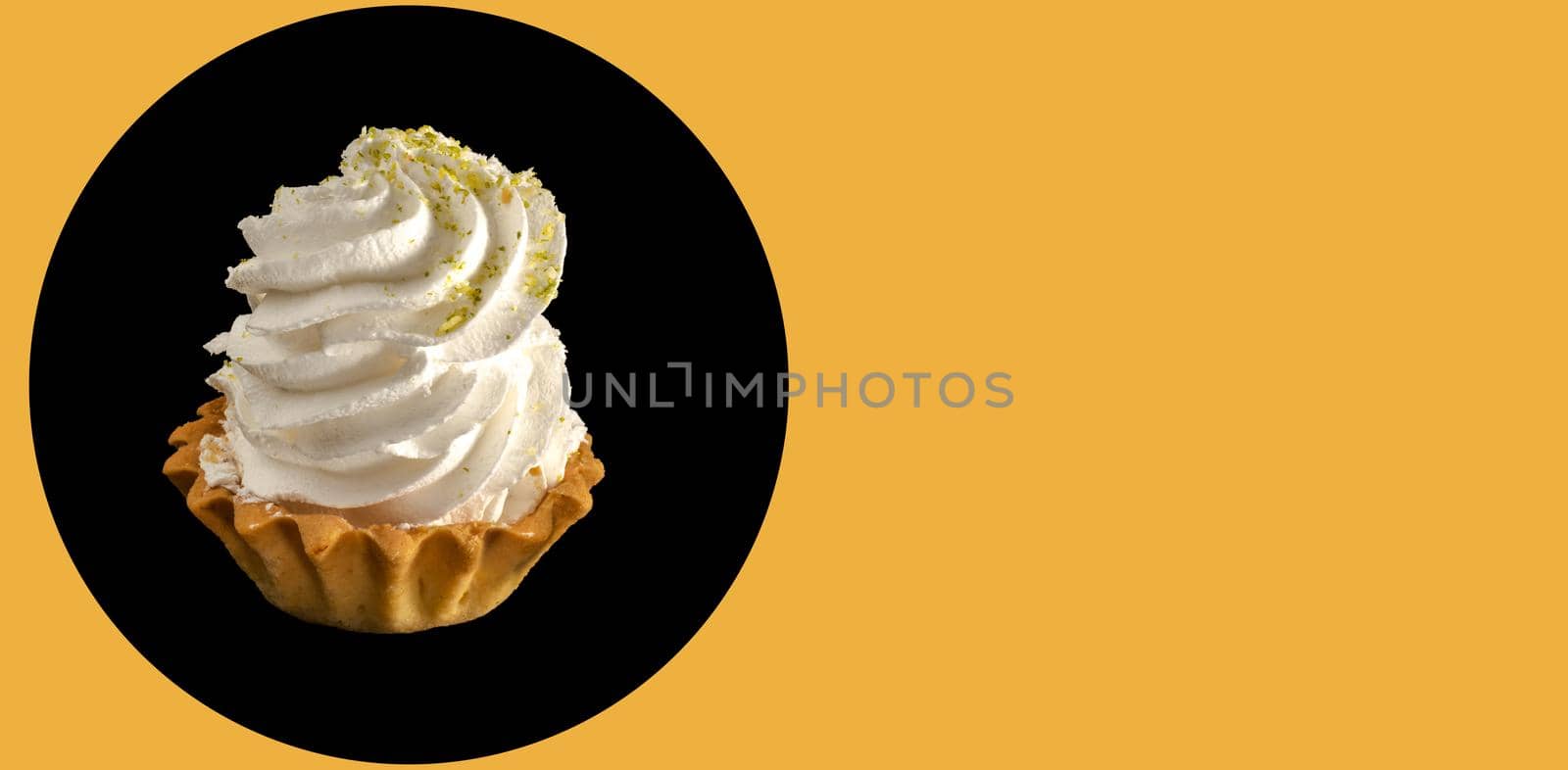 cake with protein cream on a black background isolated, place under the text on an orange background