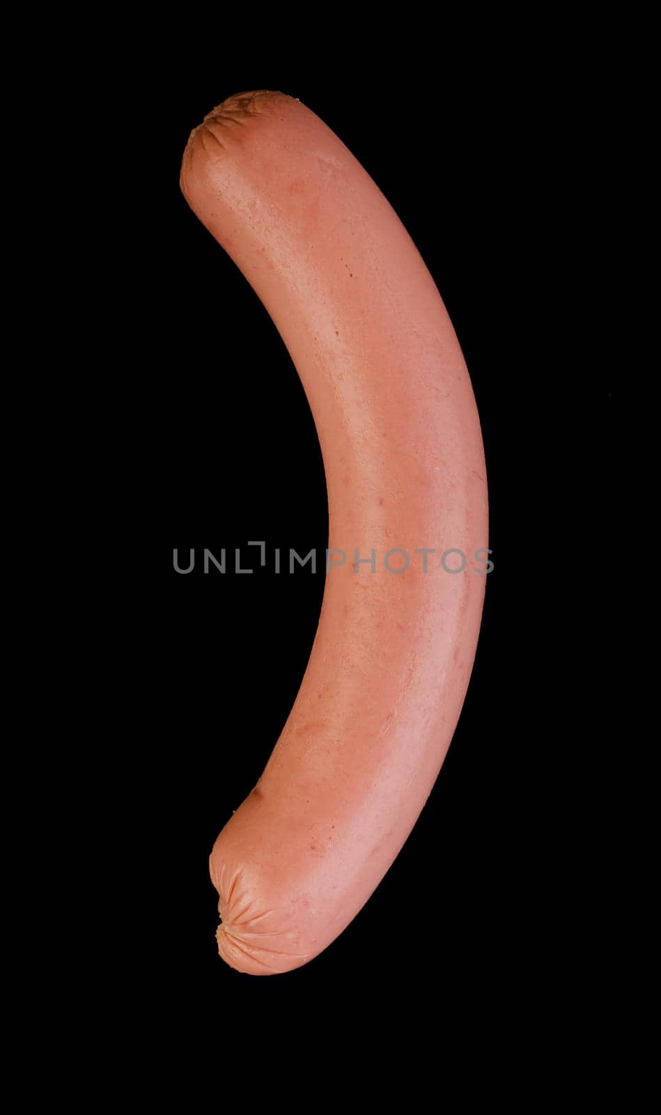 One boiled sausage is located on a black background in isolation