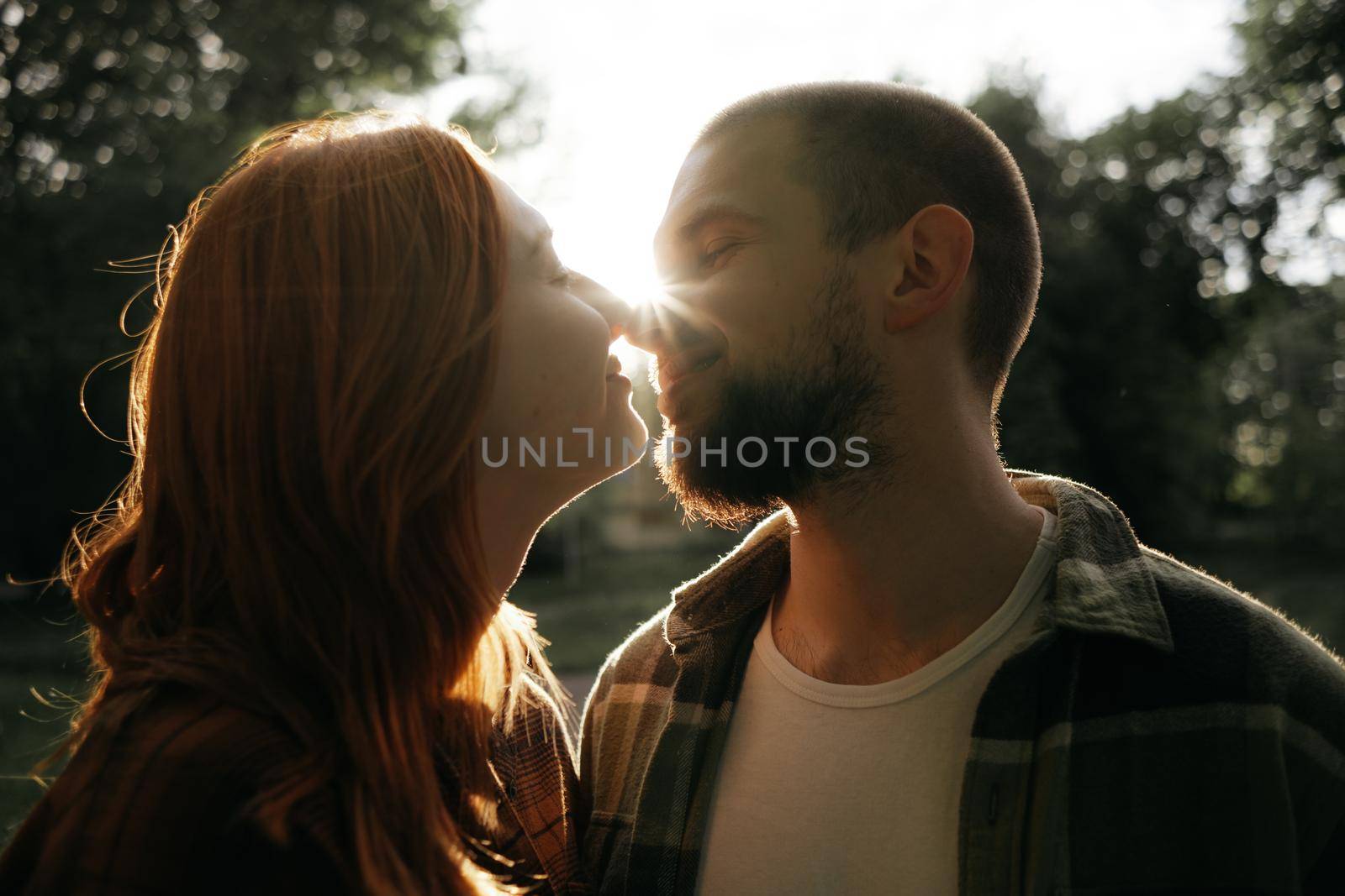 lovers kiss at sunset in the backlight by Symonenko