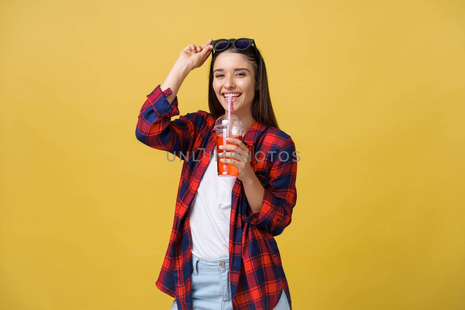 Young woman holding and drinking cold drink beverage in casual clothes. pretty girl smiling happy laughing looking at camera. by Benzoix