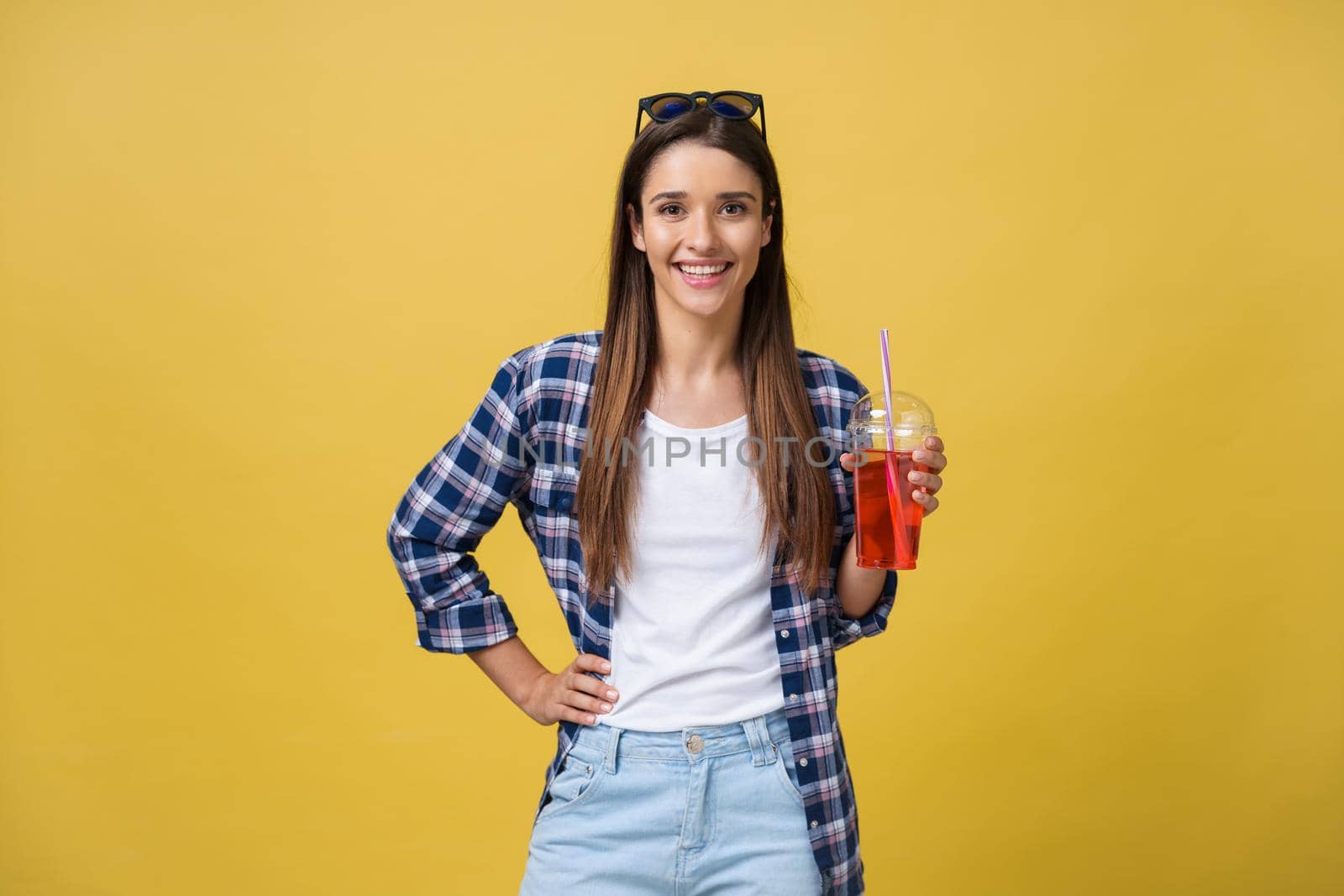 Young woman holding and drinking cold drink beverage in casual clothes. pretty girl smiling happy laughing looking at camera. by Benzoix