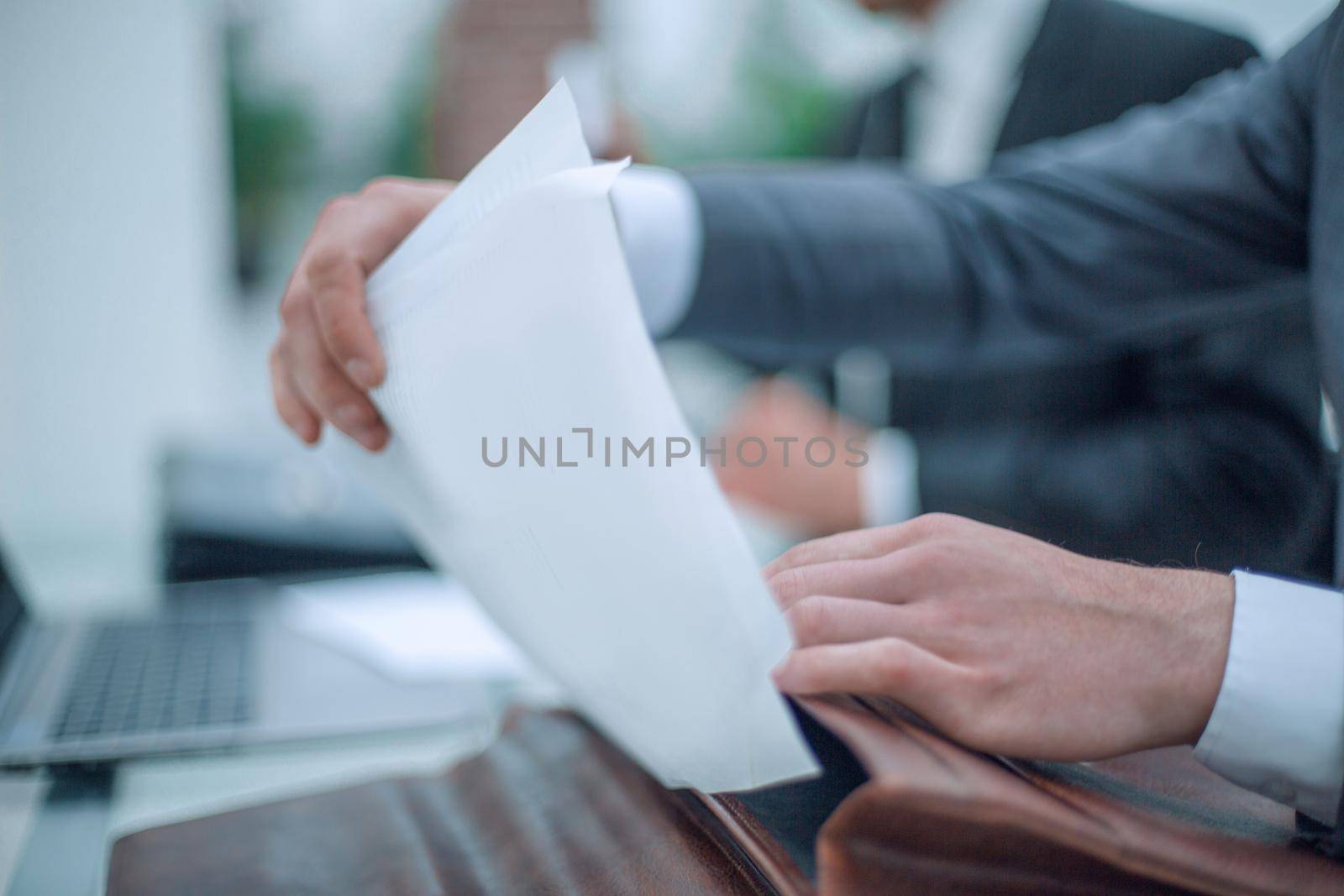 close up. businessman opening briefcase sitting at office Desk. business concept