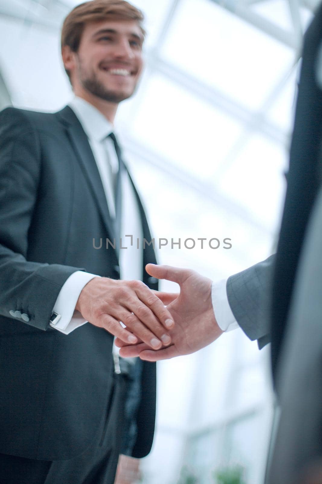 image of business people holding out their hands for a handshake. by asdf