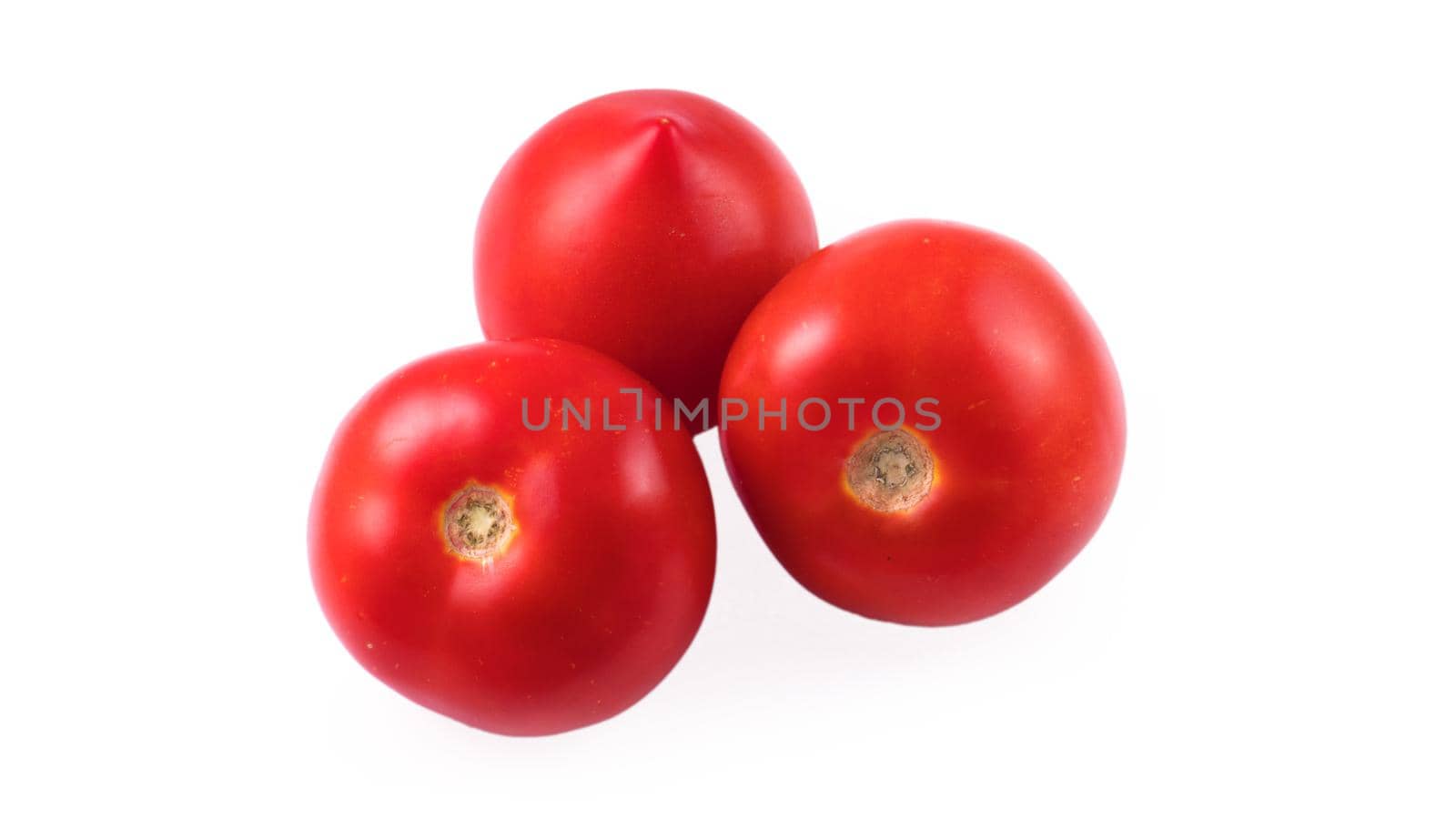 Three whole red tomatoes on a white background in isolation