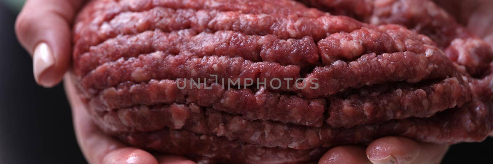 Female hands hold red minced meat, close-up by kuprevich