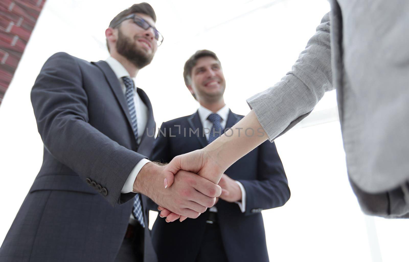 Close-up of business people shaking hands by asdf