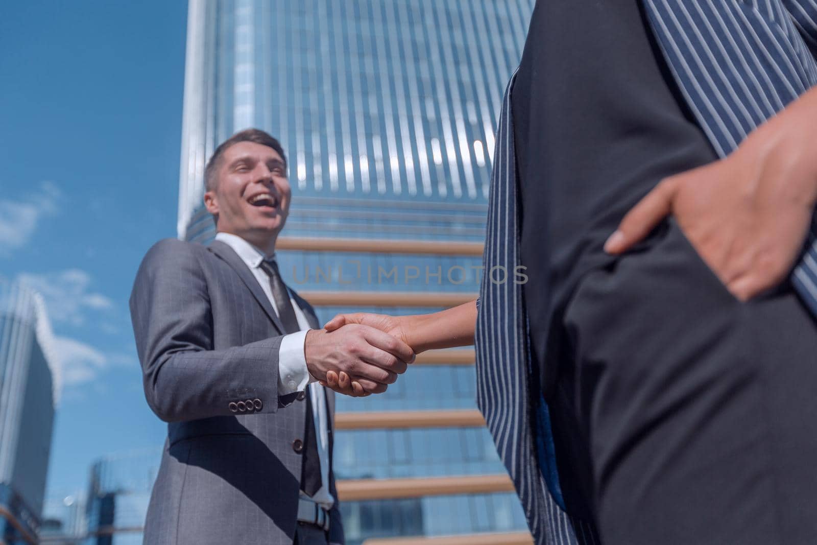 successful businessman meeting a young employee with a handshake. by asdf