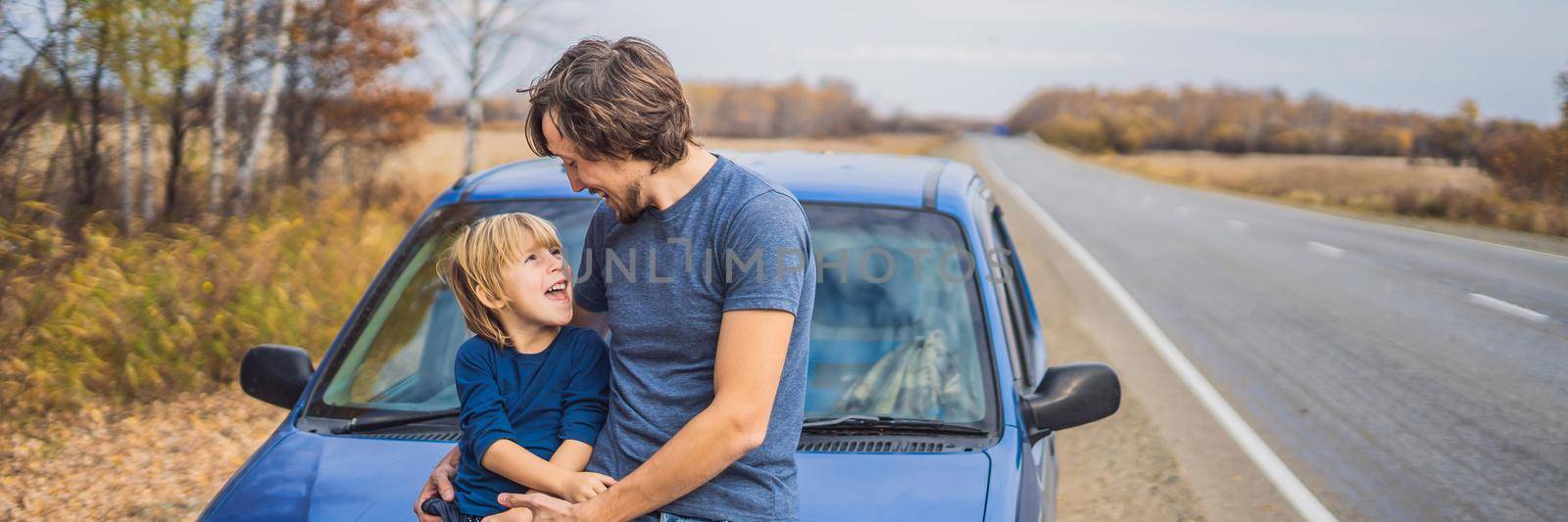BANNER, LONG FORMAT Dad and son are resting on the side of the road on a road trip. Road trip with children concept by galitskaya