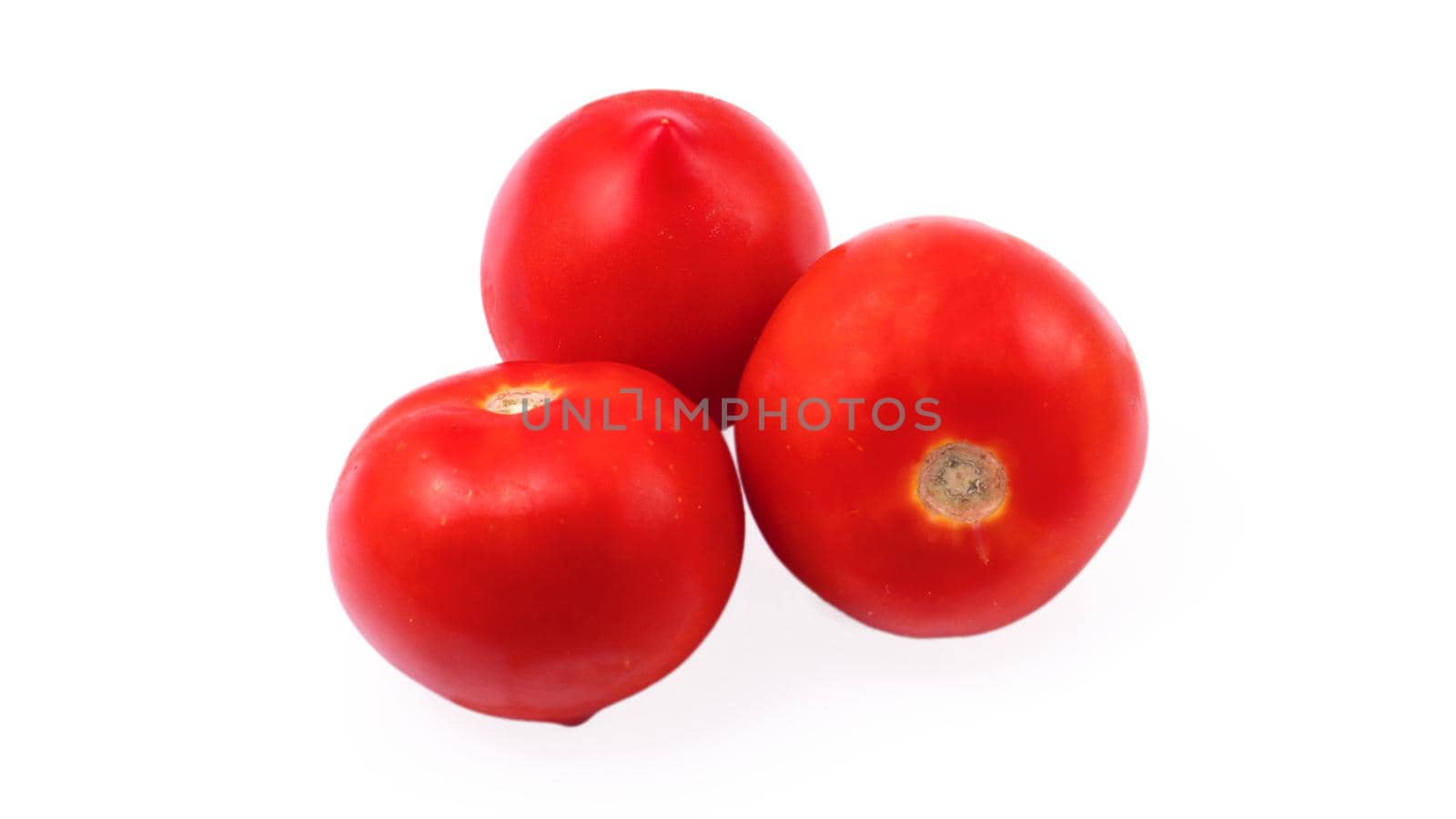 Three whole red tomatoes on a white background in isolation