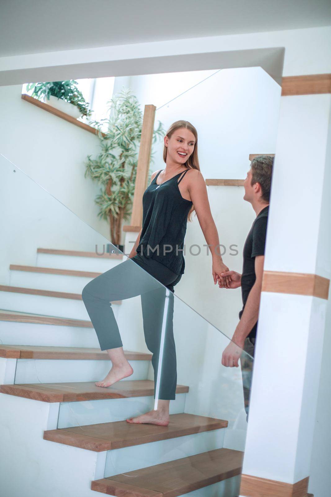 Romantic couple looking at each other while standing in new house. photo with copy space