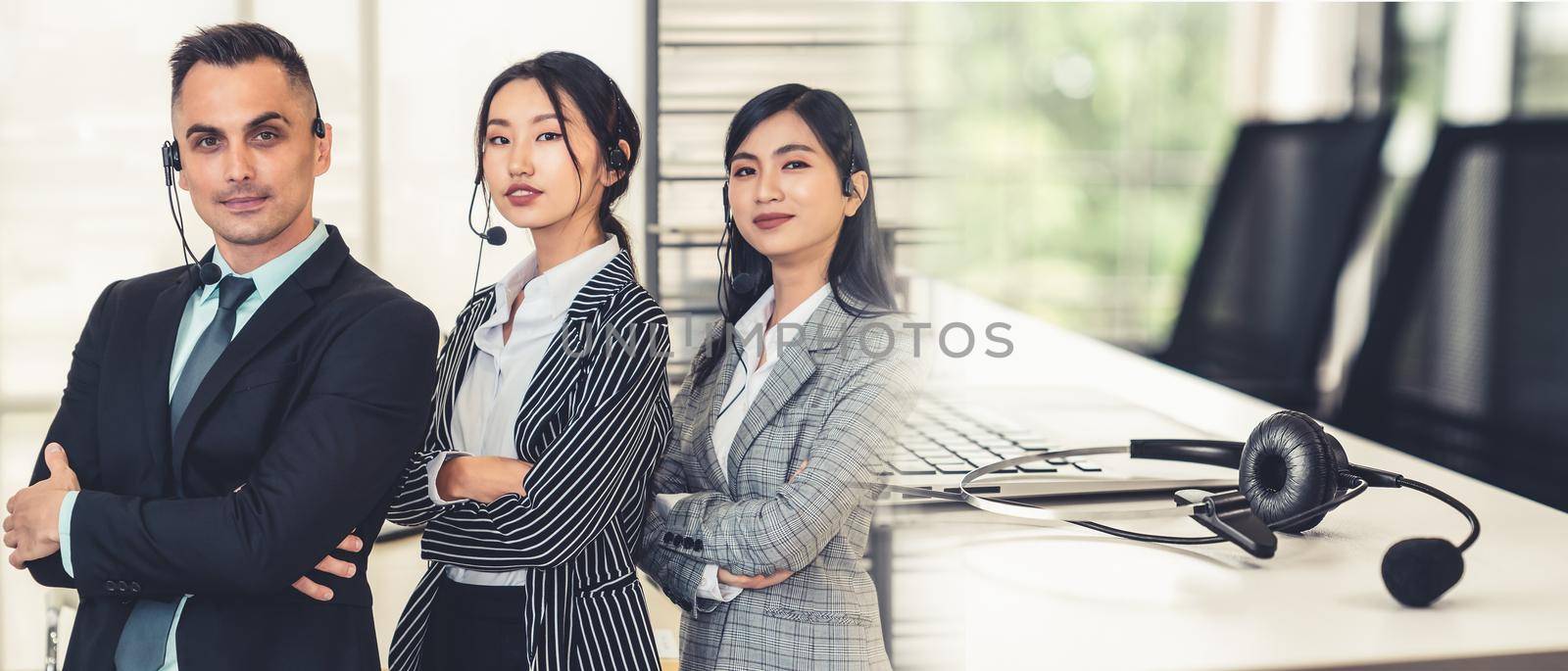 Business people wearing headset working in office to support remote customer or colleague. Call center, telemarketing, customer support agent provide service in broaden view .