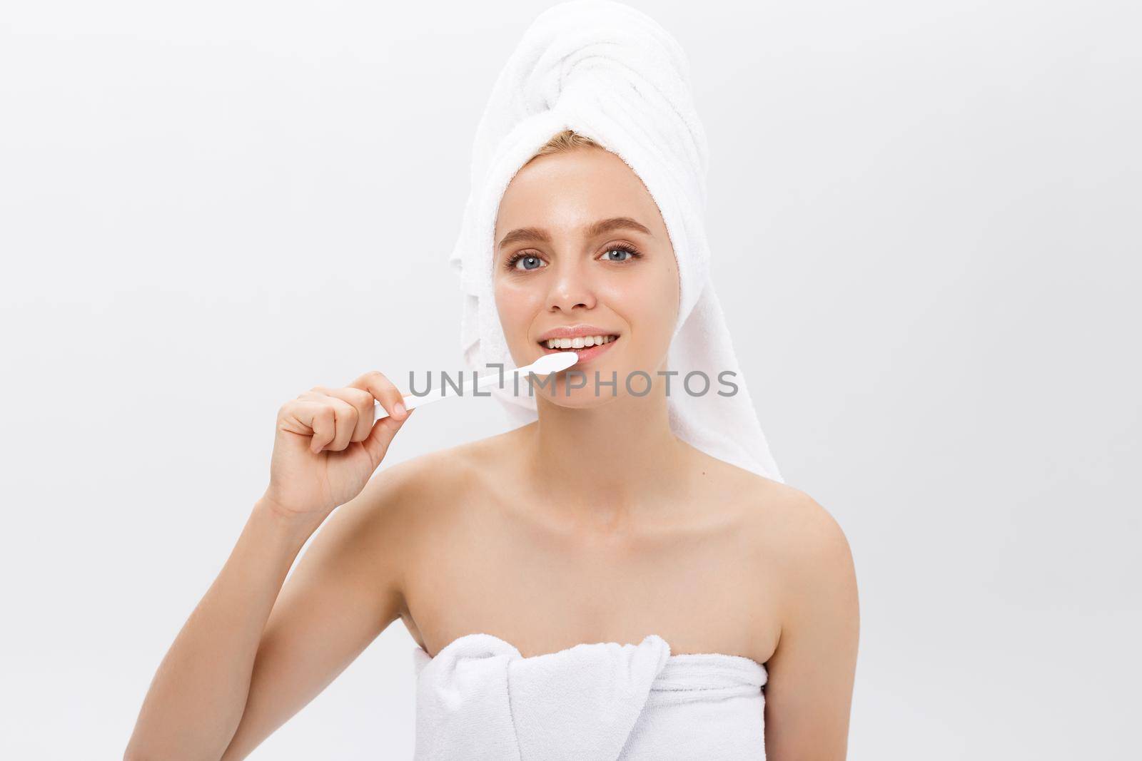 portrait of attractive caucasian smiling woman isolated on white studio shot head and shoulders face skin hand with tooth brush by Benzoix