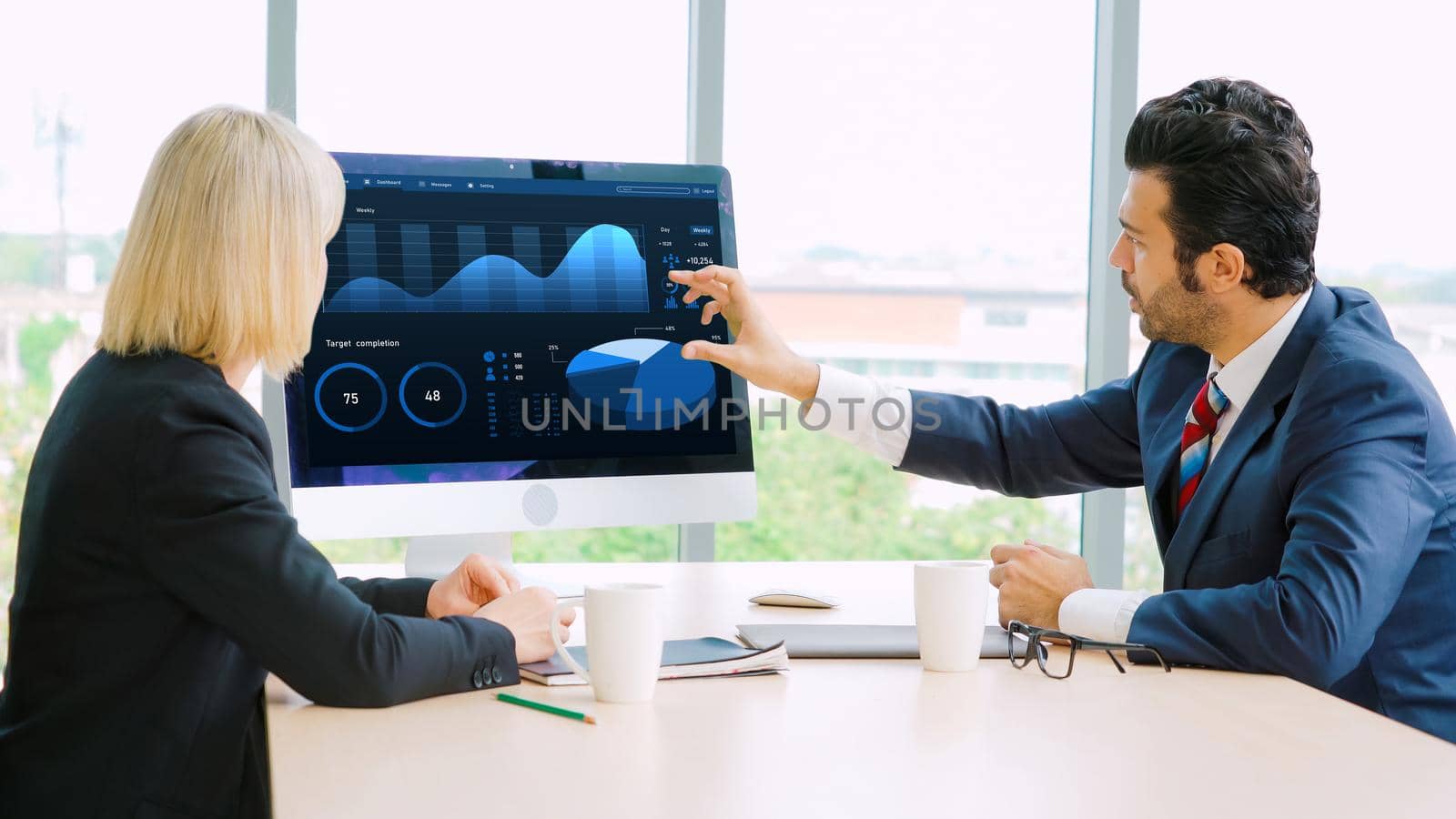 Business data dashboard analysis by ingenious computer software . Investment application display business sales and profit on the computer screen and advise marketing planning decision .