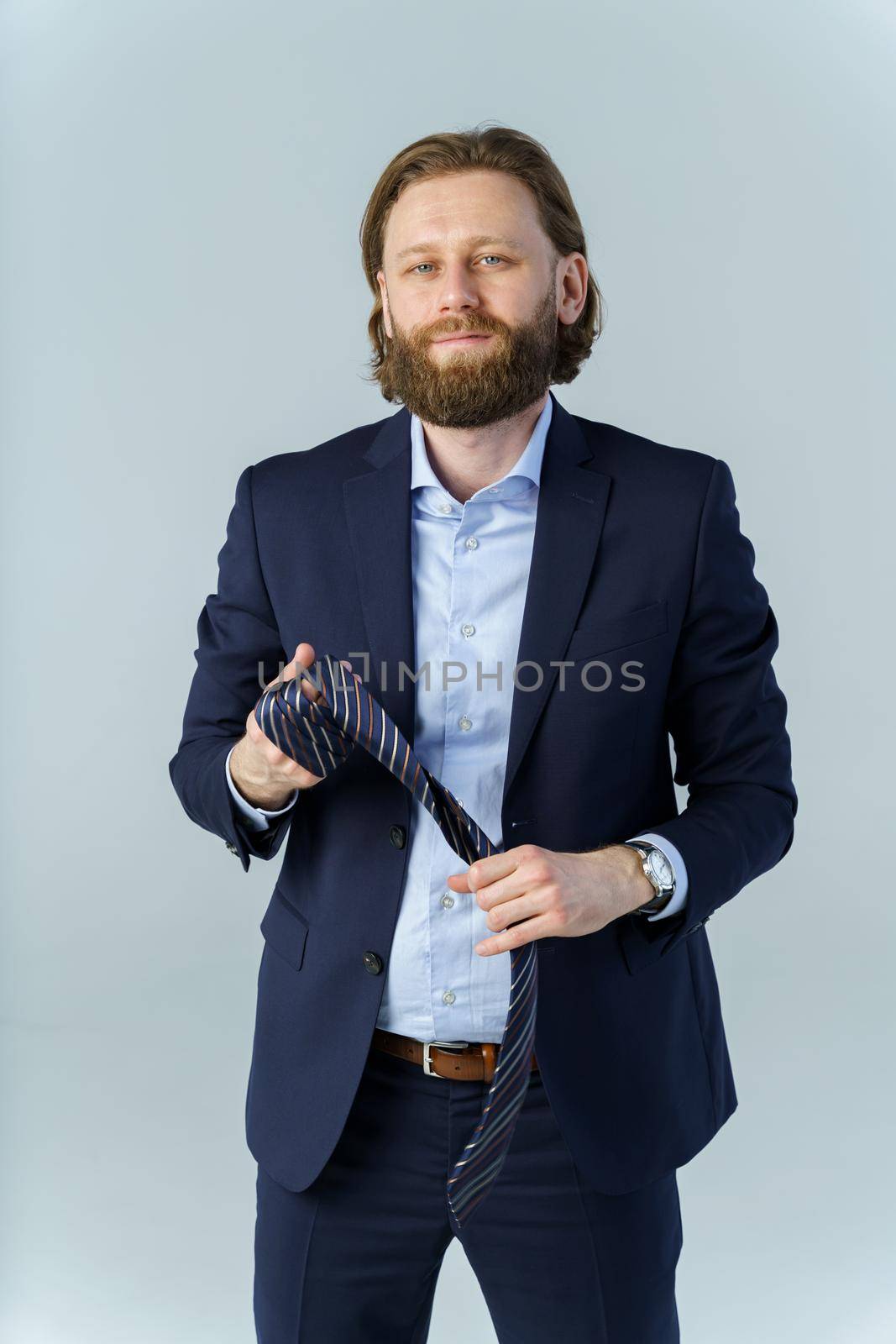 the man took off his tie and held it in his hands