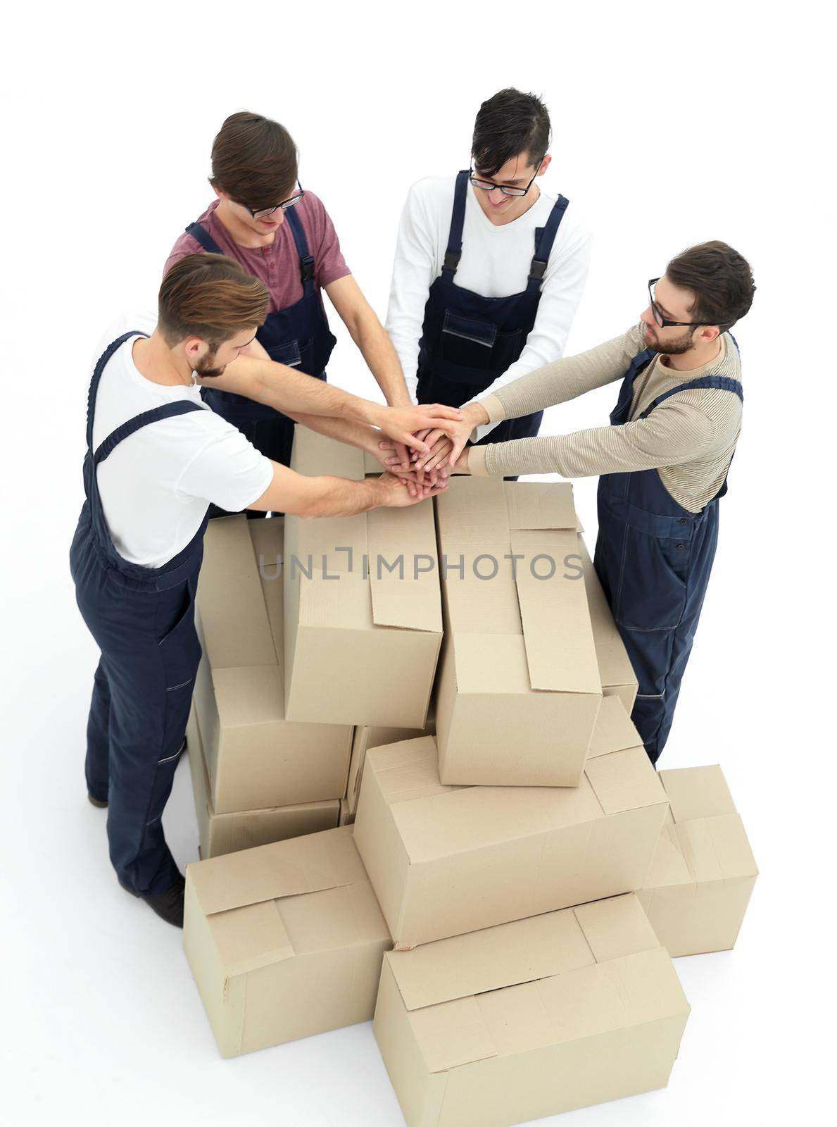 Cheerful movers leaning on stack of boxes isolated on white back by asdf