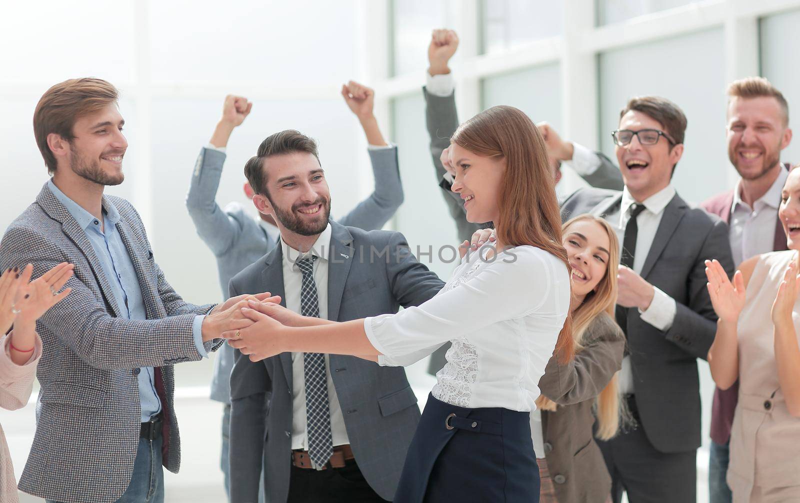 happy employees congratulating their leader. the concept of victory by asdf