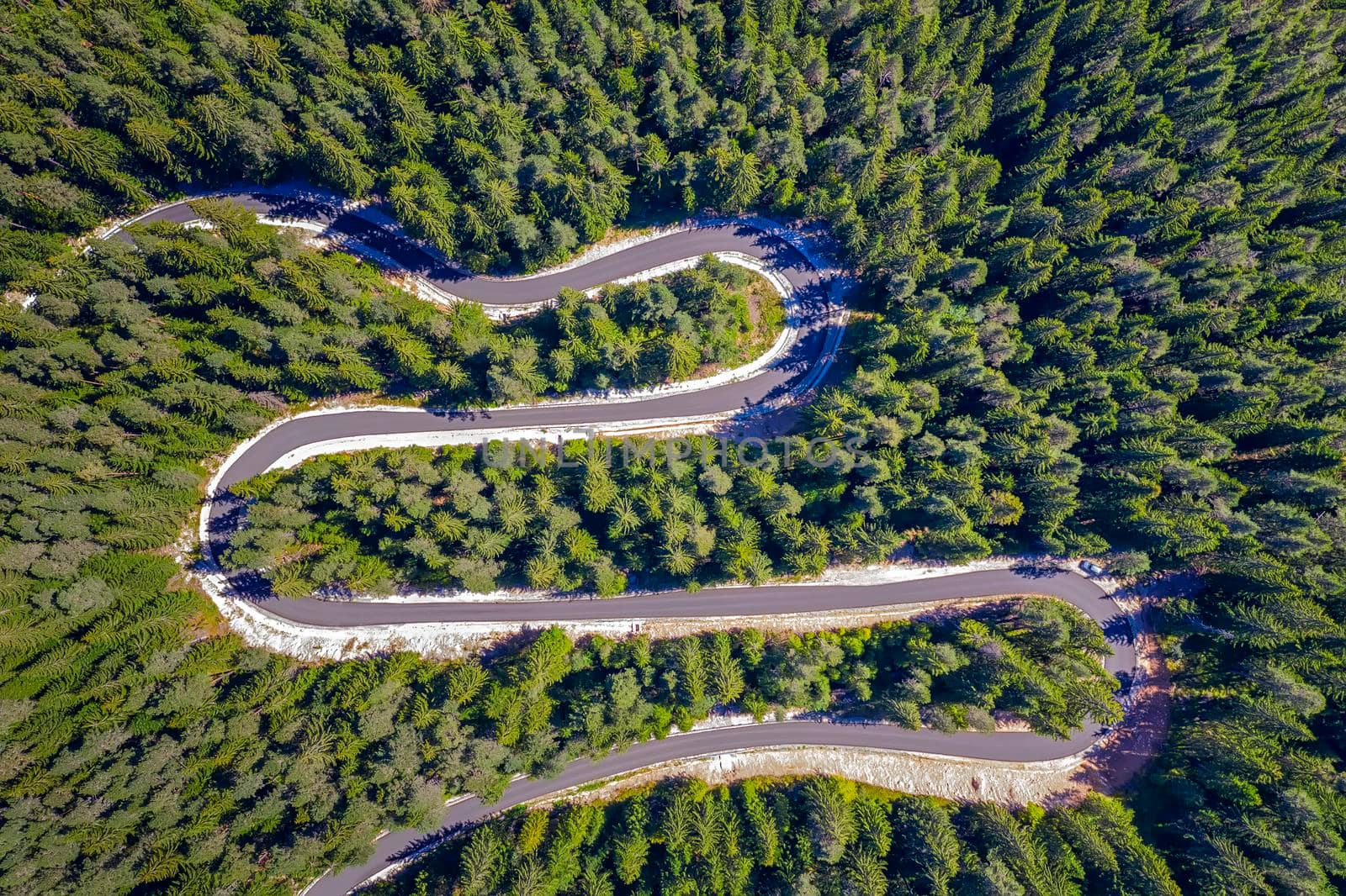 Aerial view from drone of curves of mountain road. Transportation and infrastructure concept