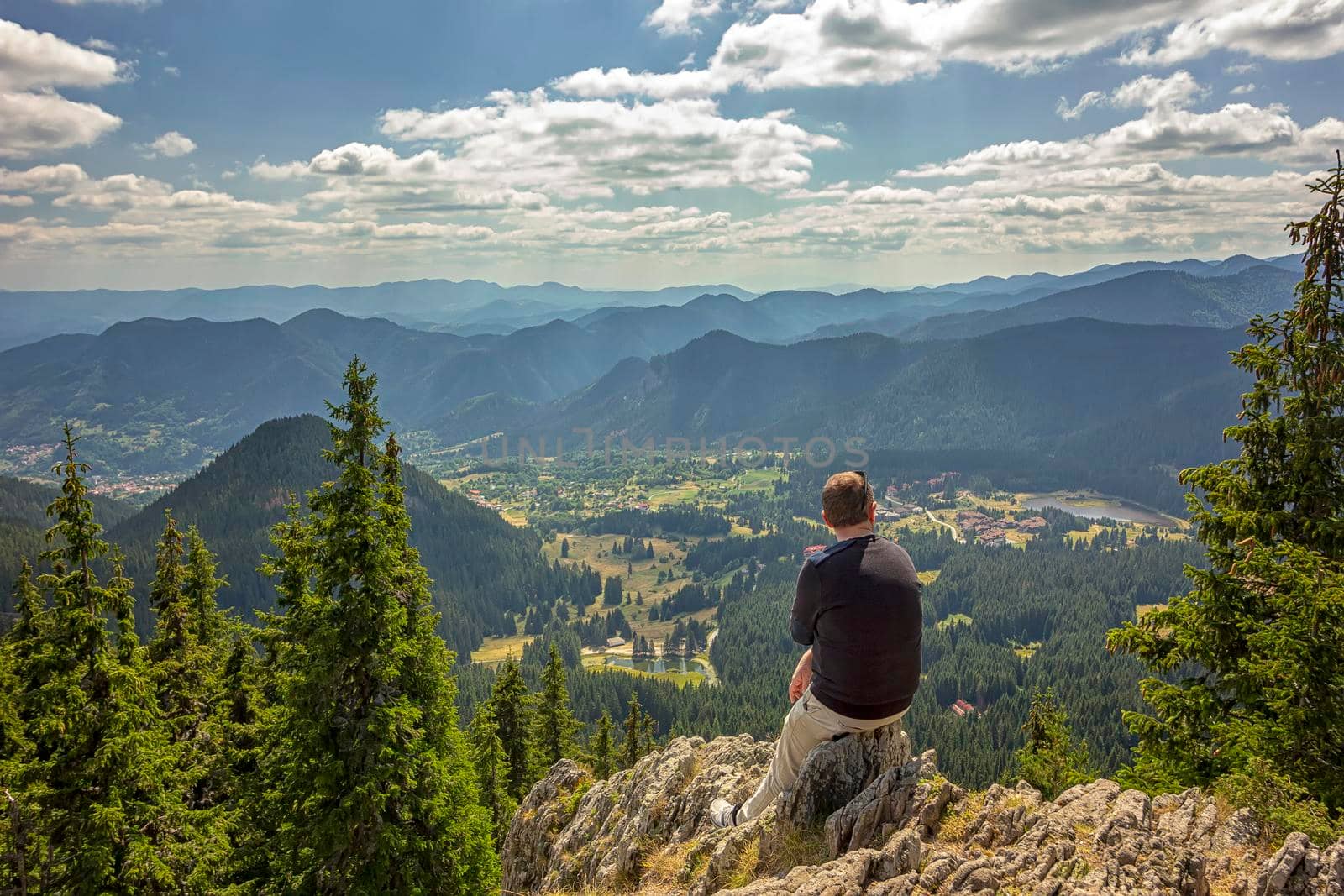 A man enjoys a beautiful view from top .Travel in the mountains.  by EdVal