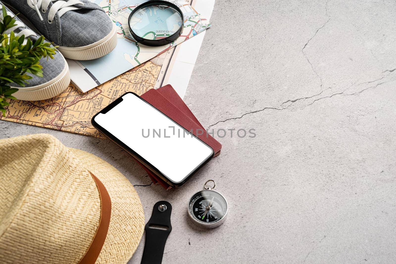 travel plan, trip and vacation, technology. Top view travel accessories with shoes, map, smartphone with mockup screen, hat. Copy space