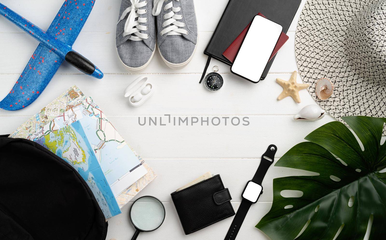 travel plan, trip and vacation, technology. Top view travel accessories with shoes, map, smartphone with mockup screen, hat. Copy space