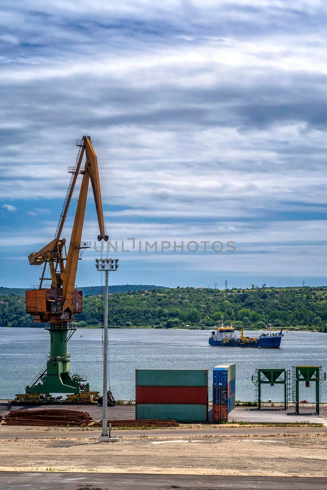 Port crane ready to load containers to cargo ships.  by EdVal