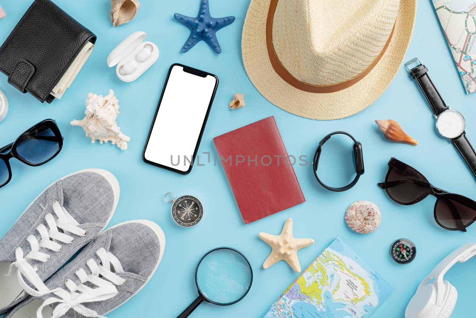 travel plan, trip and vacation, technology. Top view travel accessories with shoes, map, smartphone with mockup screen, hat. Copy space