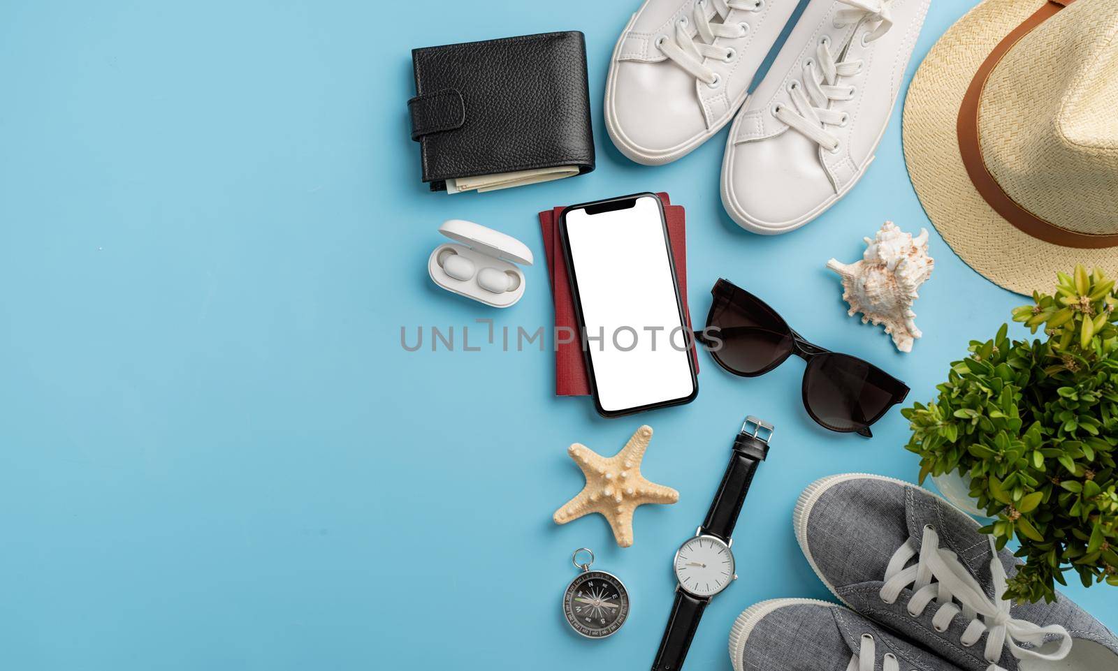 travel plan, trip and vacation, technology. Top view travel accessories with shoes, map, smartphone with mockup screen, hat. Copy space