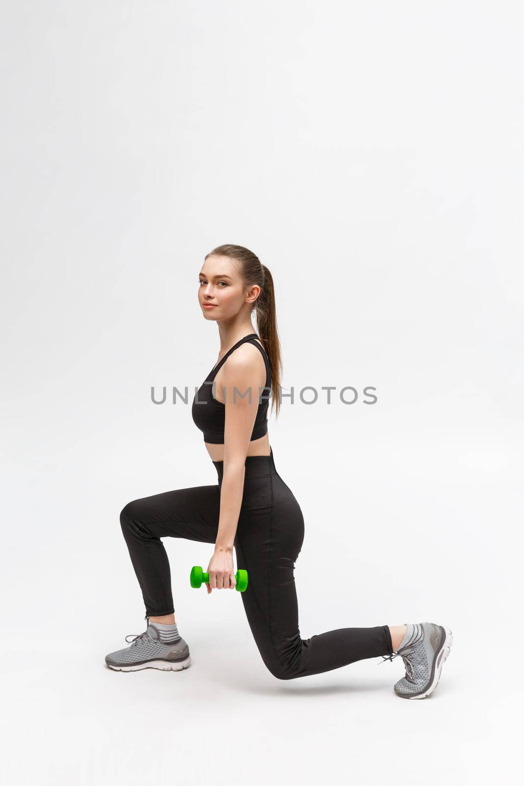 Exercise. Sports Woman In Fashion Sportswear Stretching Legs.