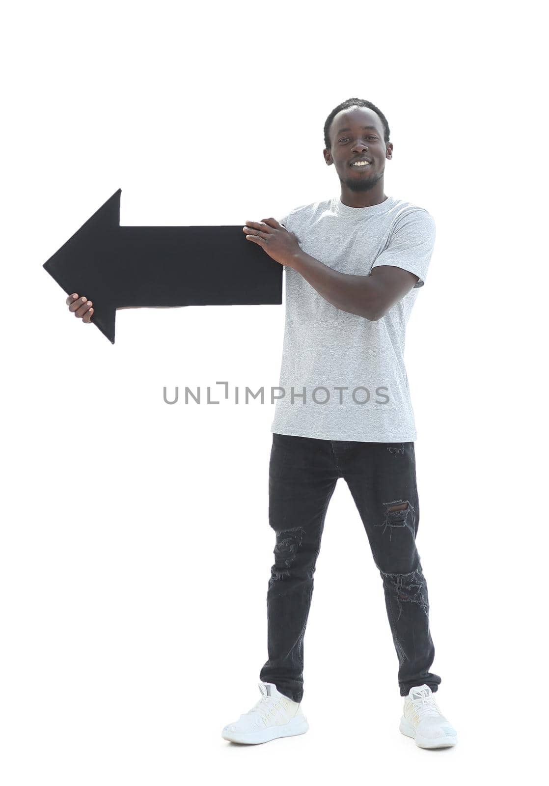 in full growth. casual guy pointing in the right direction. isolated on white background