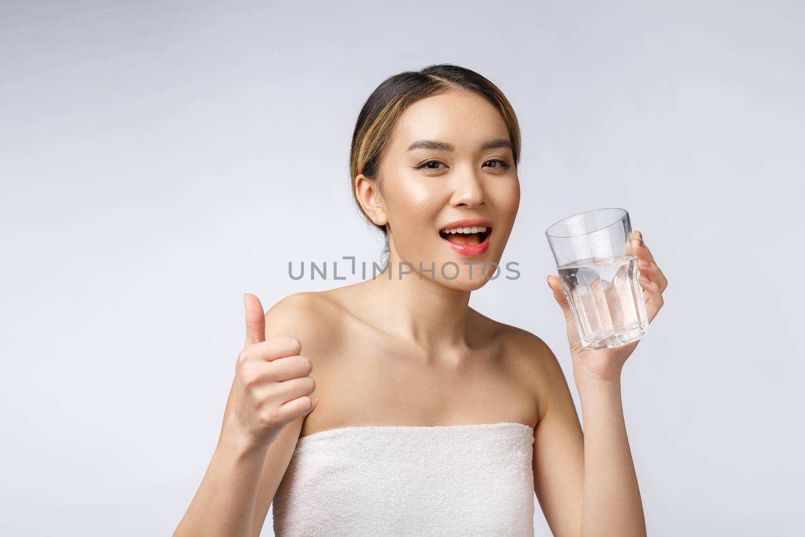 relaxed young smiling woman drinking clean water