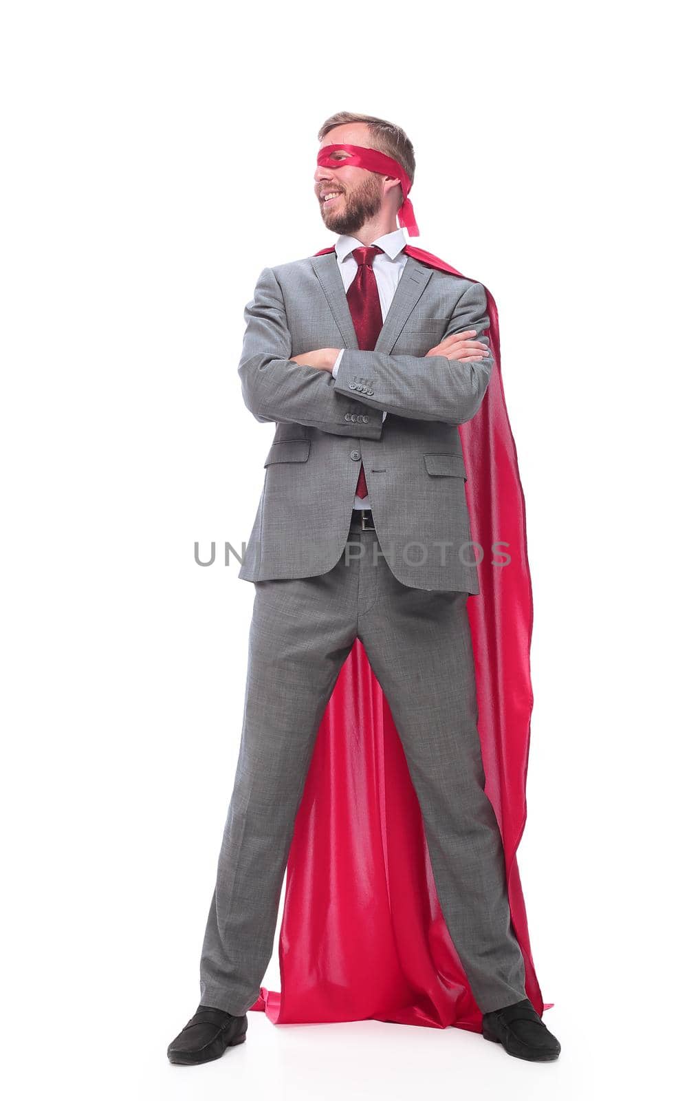 in full growth. confident businessman superhero looking at copy space . isolated on white