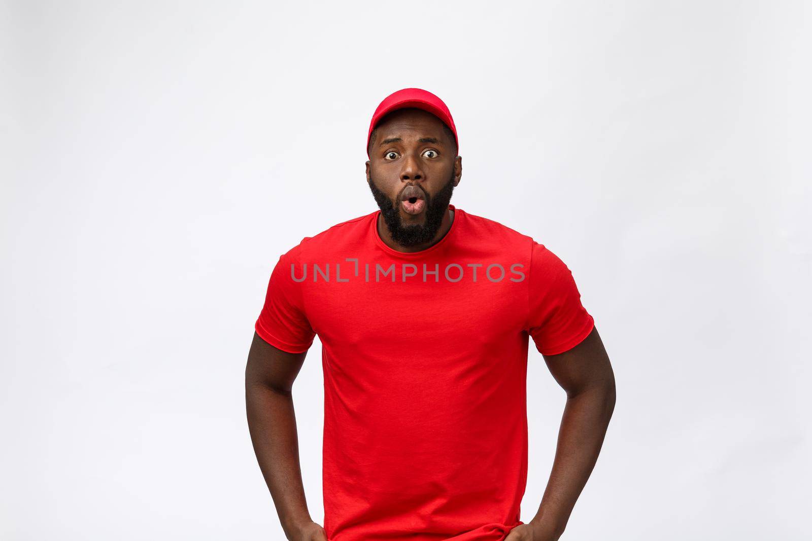 Young african american man with shocking face. Isolated over Grey background