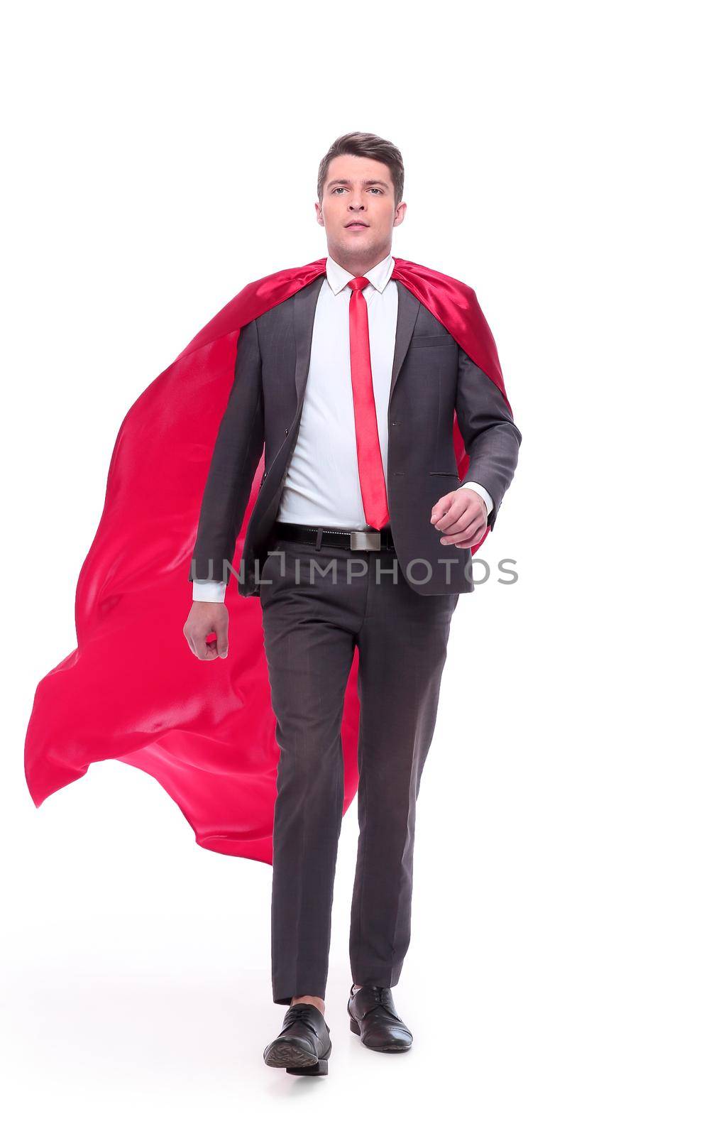 in full growth. confident businessman in superhero Cape striding forward.