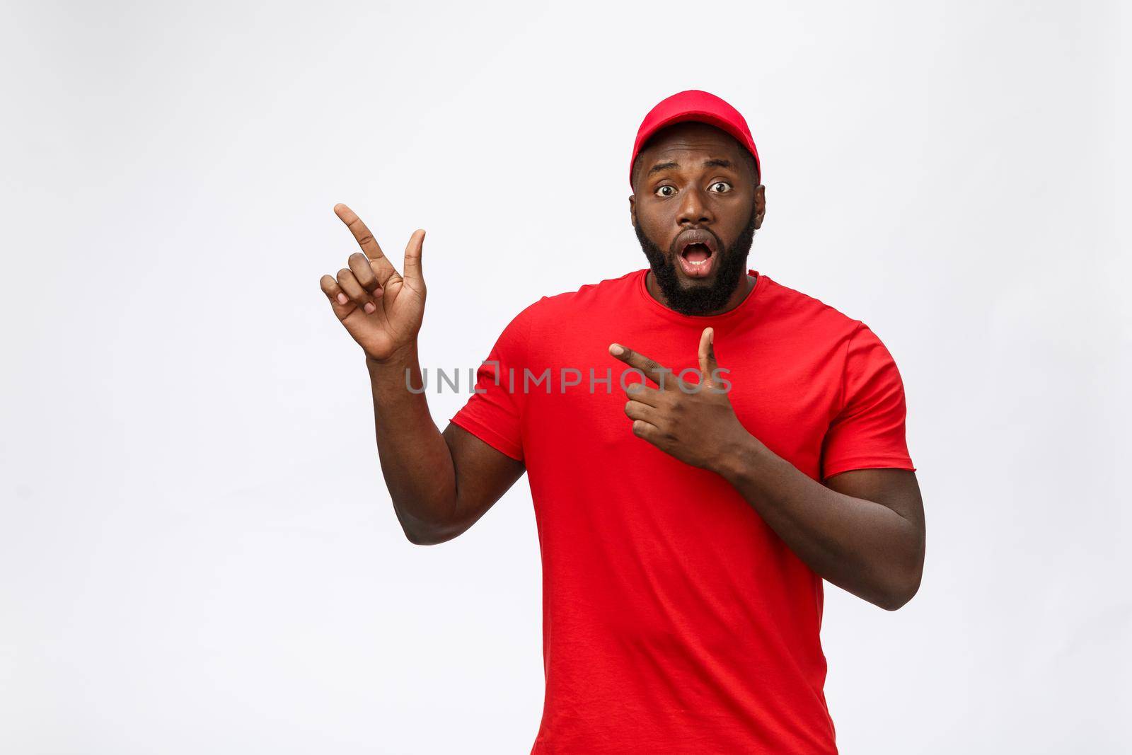African american man over isolated background surprised with an idea or question pointing finger with surprise face. by Benzoix