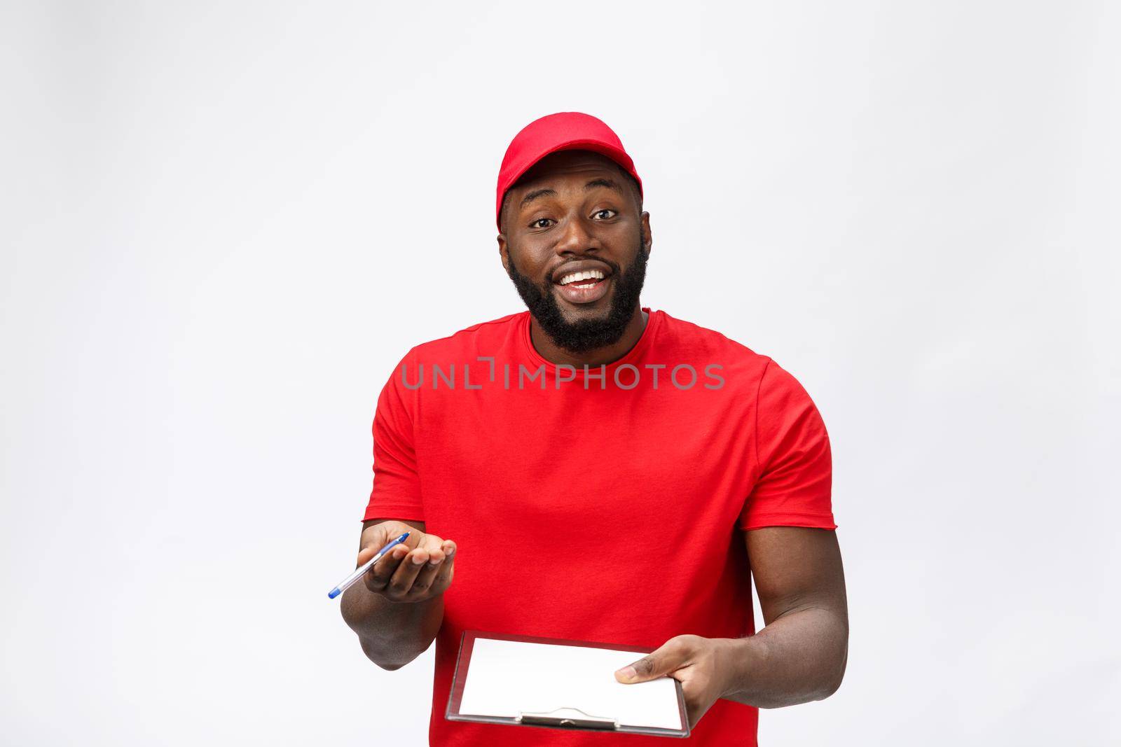 Delivery Concept - Portrait of Handsome African American delivery man or courier showing a confirmation document form to sign. Isolated on Grey studio Background. Copy Space by Benzoix