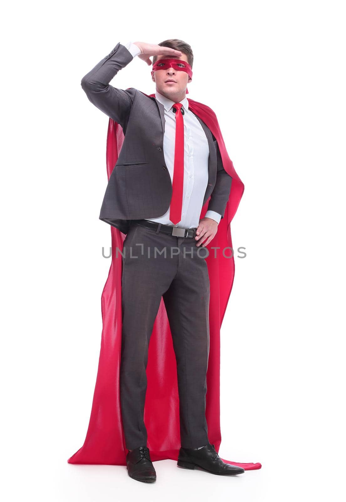 in full growth. attentive superhero businessman looking into the distance. isolated on white