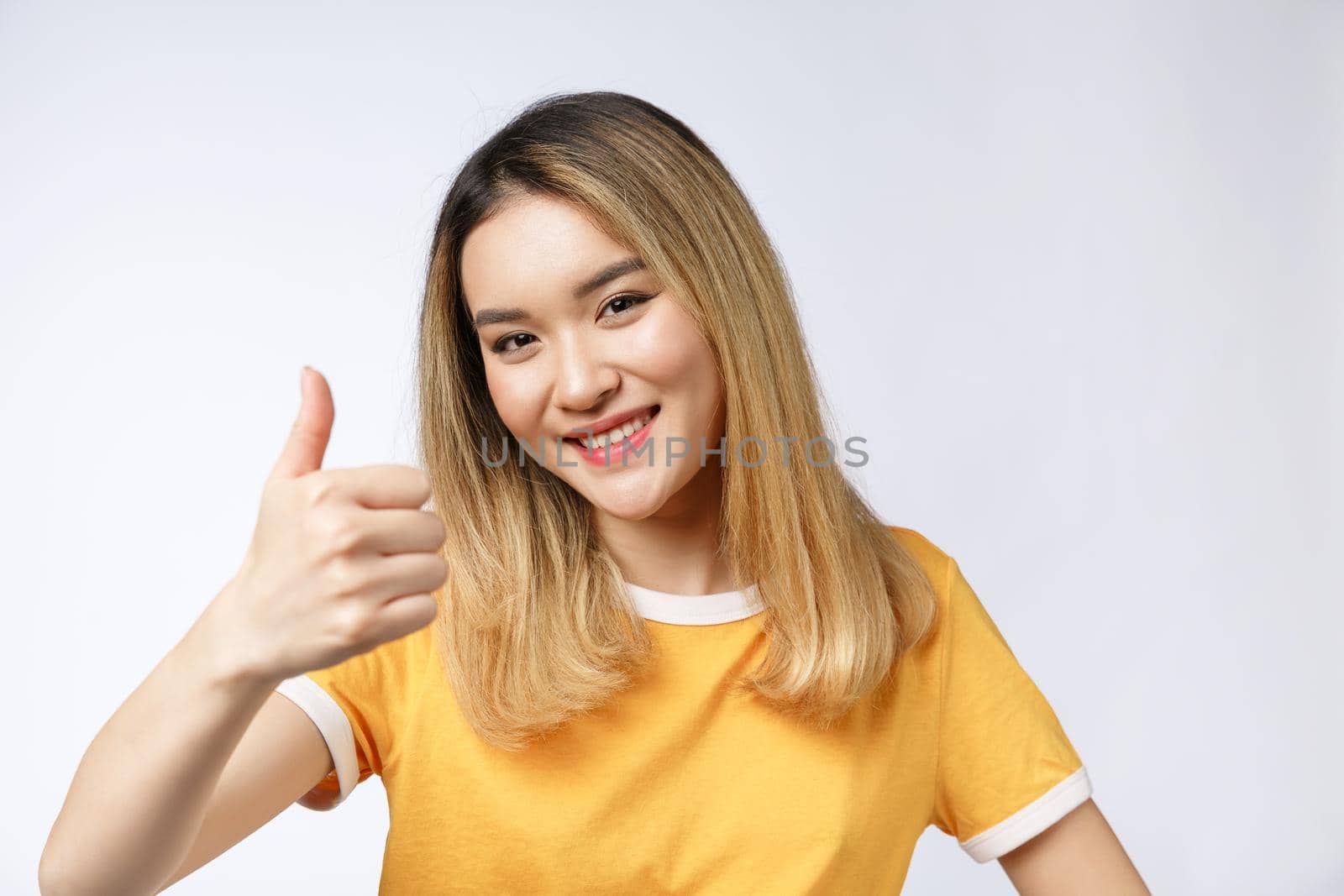 Young Asian woman show thumbs up on white background