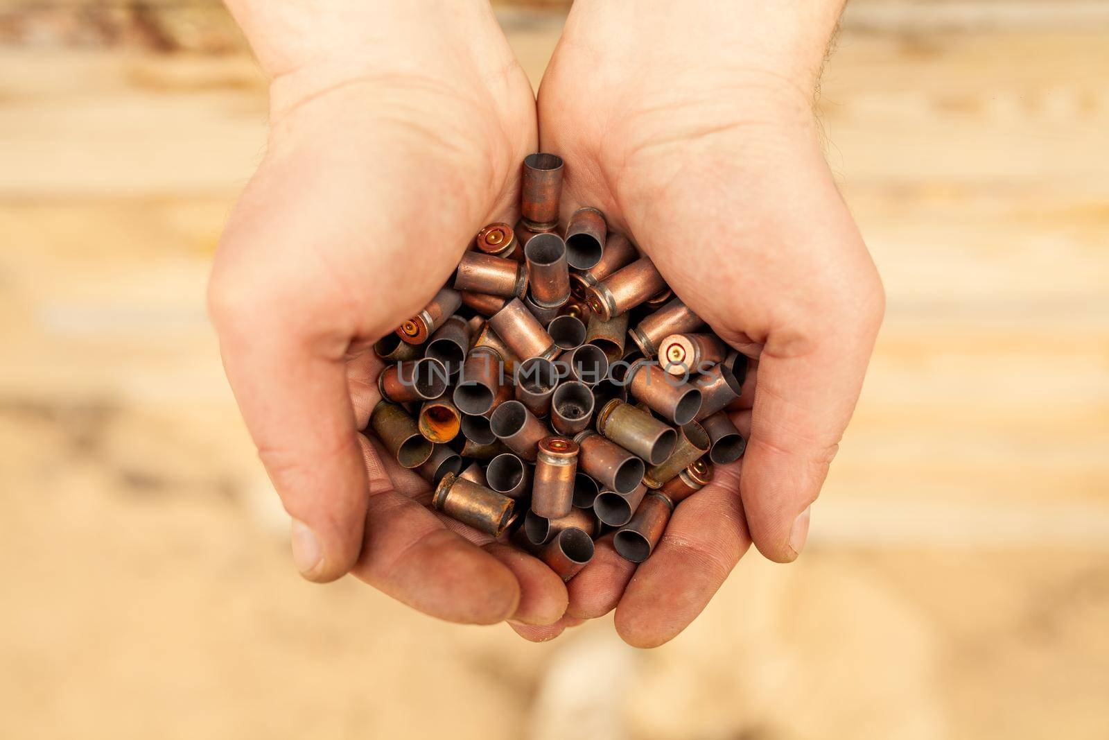 cases from the military cartridges in the hands of the men of war concept