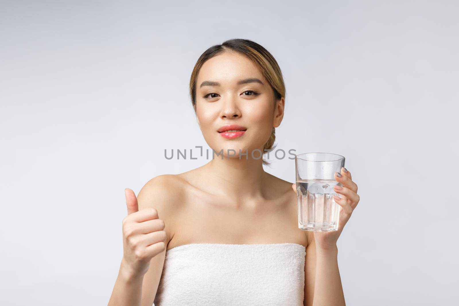 relaxed young smiling woman drinking clean water