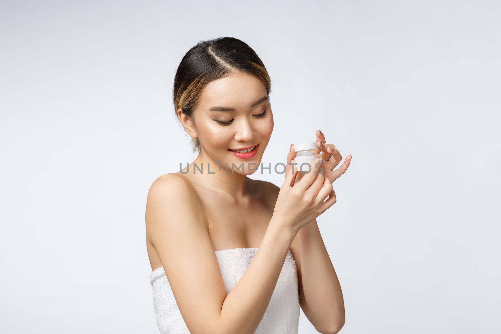 Beautiful Asia woman presenting product isolated on white background. COPY SPACE