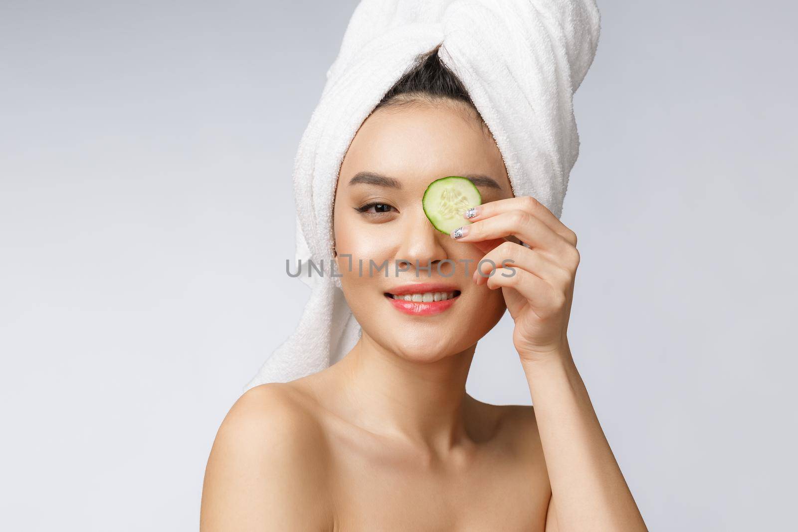 Beauty young asian women skin care image with cucumber on white background studio