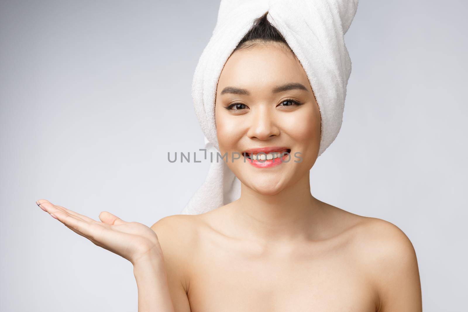 Portrait beautiful asian woman wow surprised and pointing hand to the right side on gray background, emotions action, showing your product or message by Benzoix