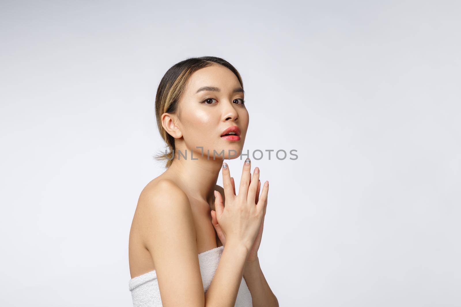 Sided portrait of Asian beautiful smiling girl with short hair showing her healthy skin on the isolated white background by Benzoix