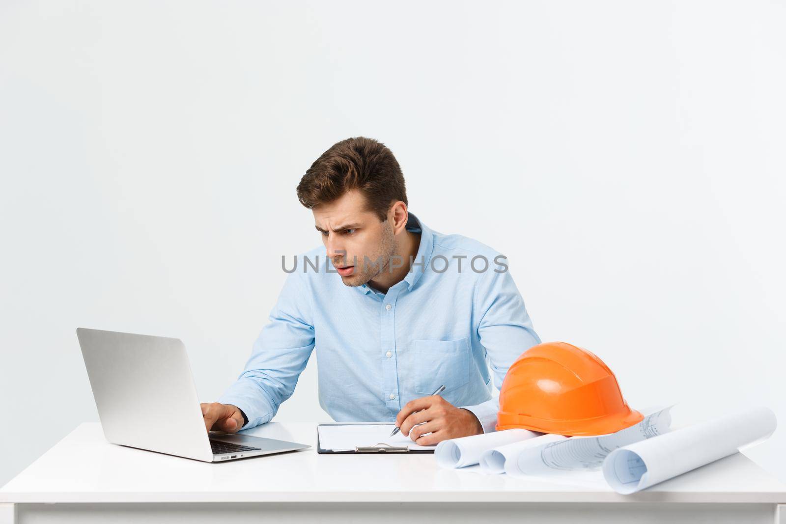 Handsome young man serious working in engineering office
