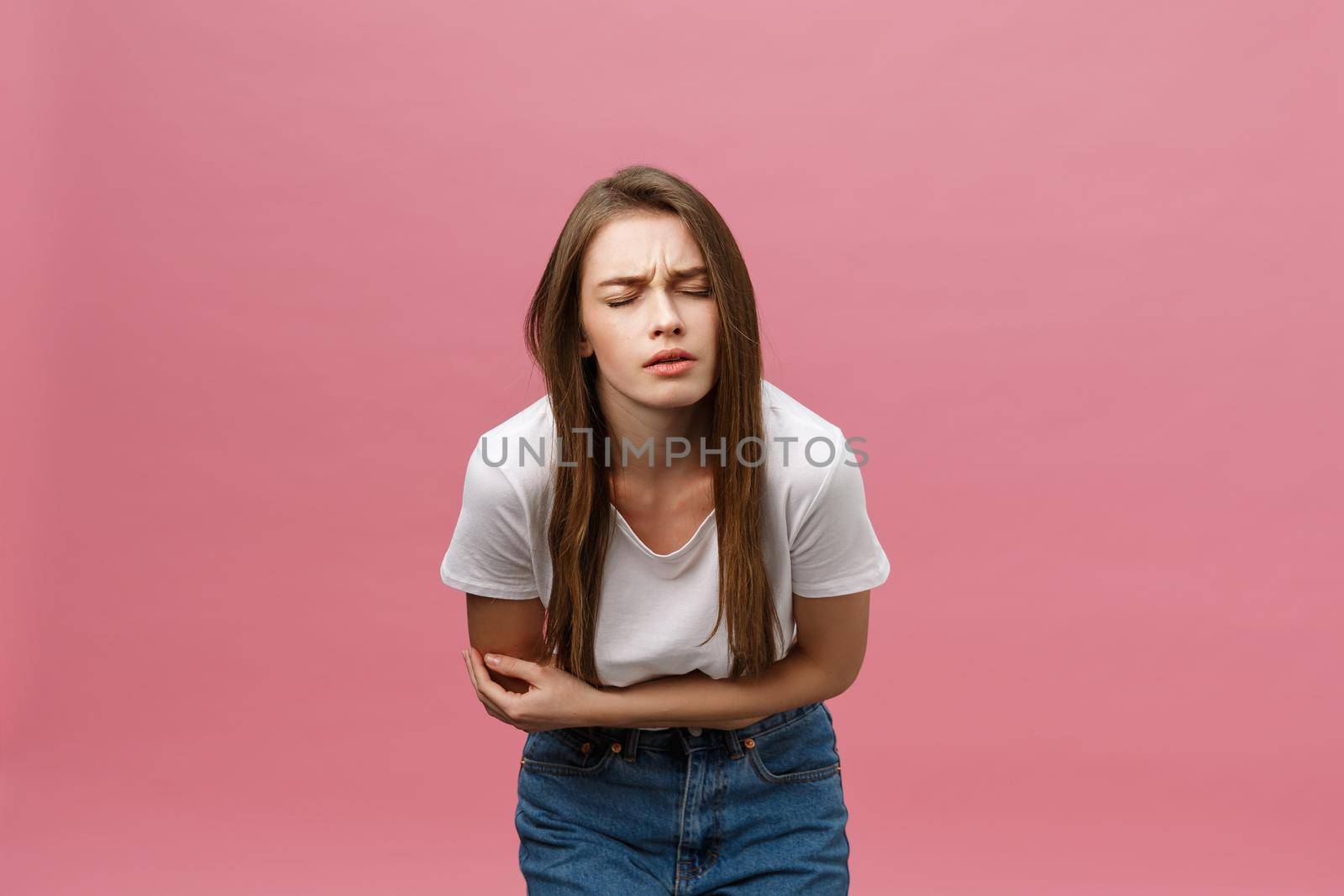 Young caucasian woman over isolated background with hand on stomach because indigestion, painful illness feeling unwell. Ache concept by Benzoix