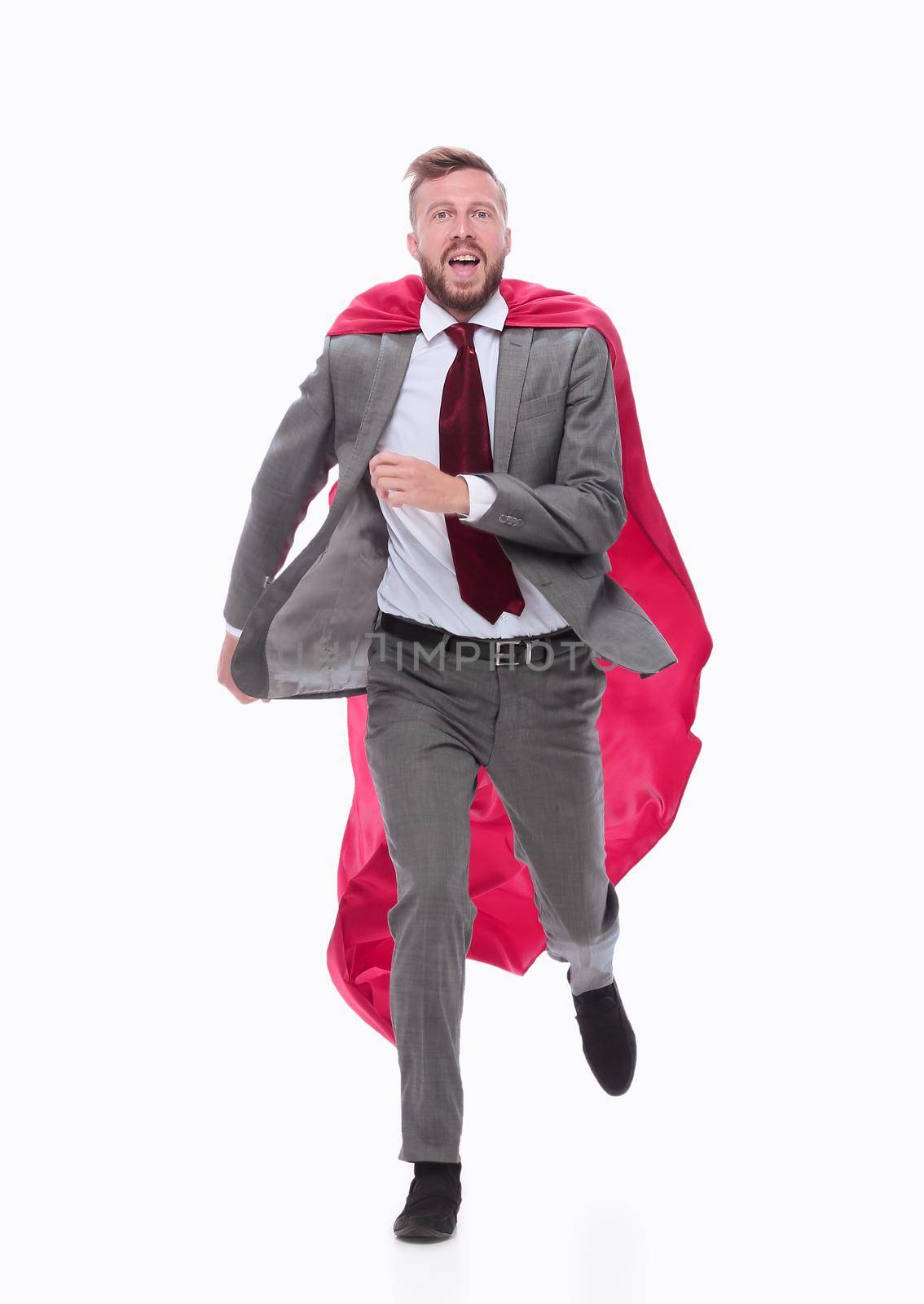 in full growth. serious businessman in a superhero raincoat striding confidently forward.